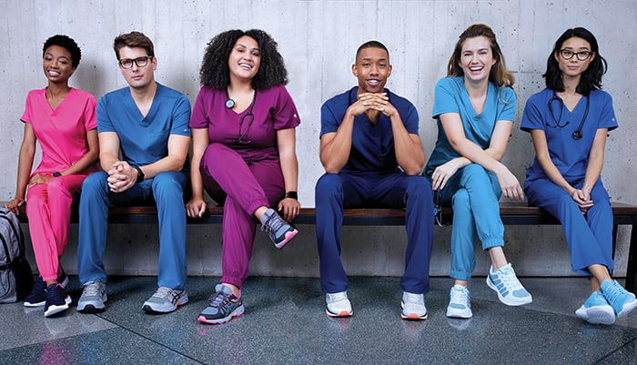 Healthcare workers in colored scrubs