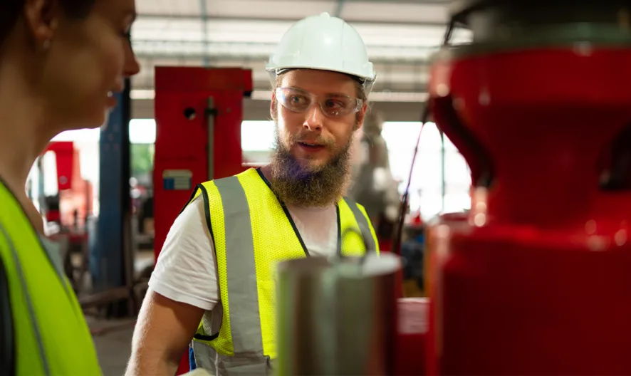Industrial worker wearing safety vest and hard hat