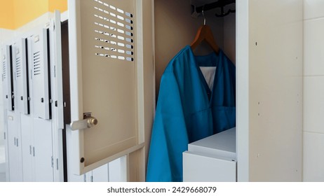 Clean uniforms hanging in a workplace locker room